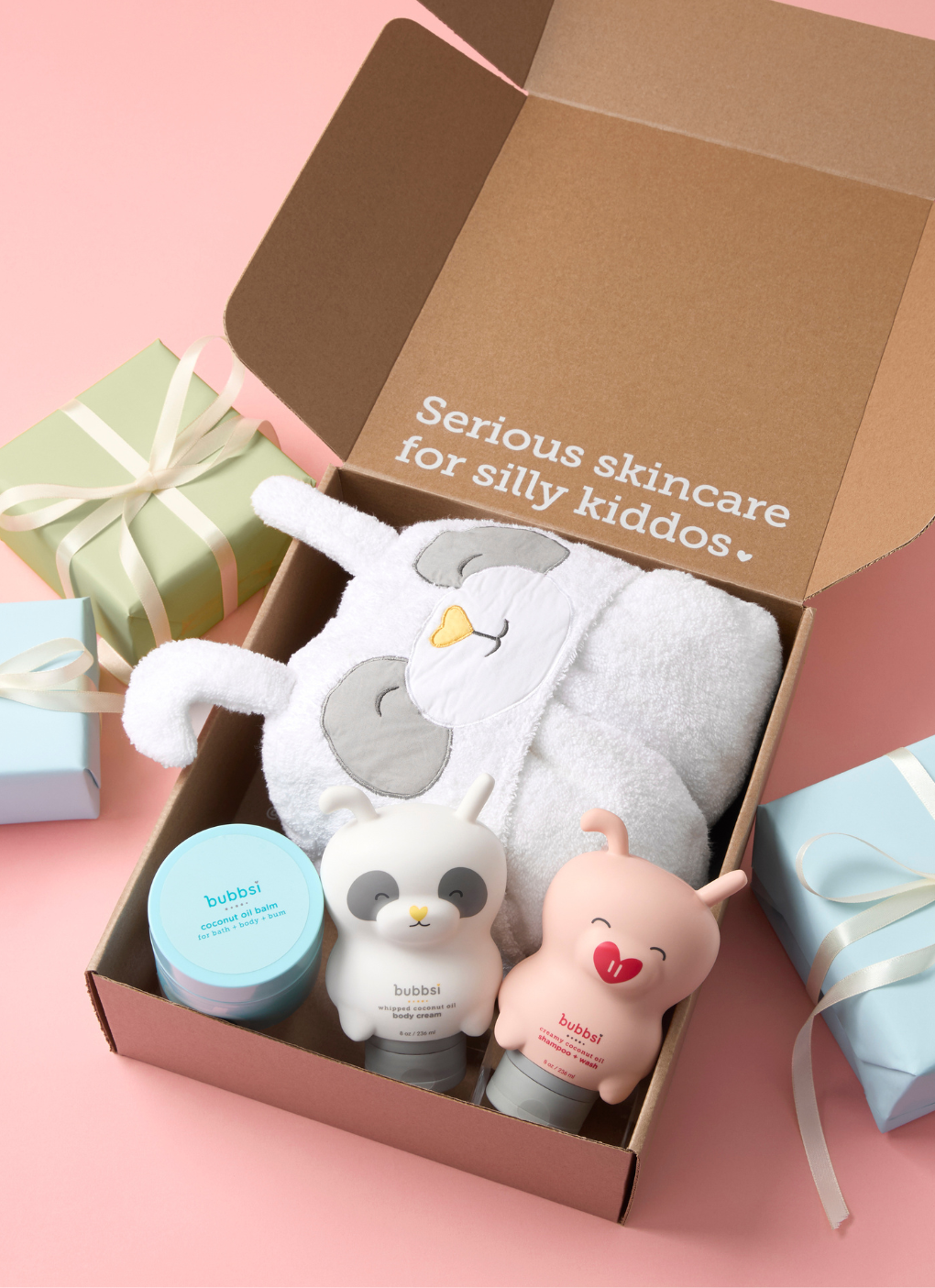 Children's skincare set with plush toys in a box on a pink background